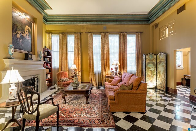 sitting room featuring ornamental molding and a high end fireplace