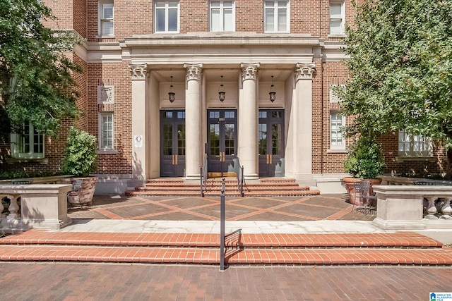 view of exterior entry featuring covered porch