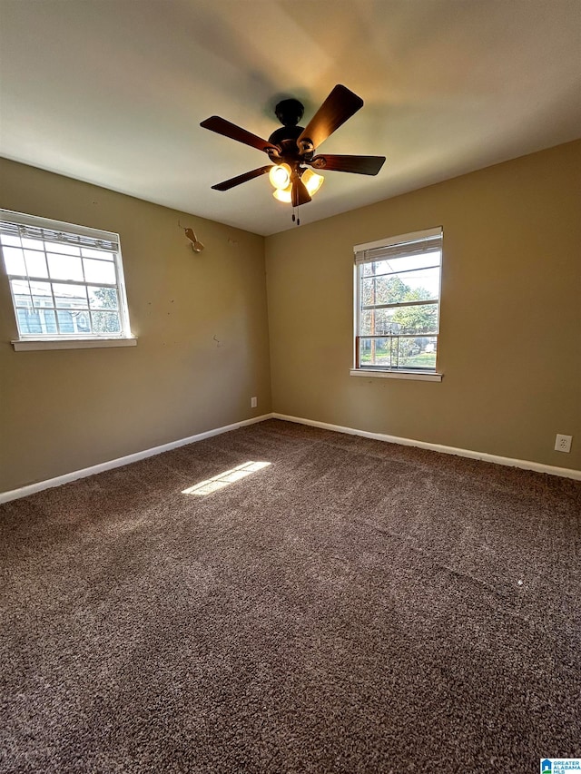 unfurnished room featuring a ceiling fan, carpet flooring, and baseboards