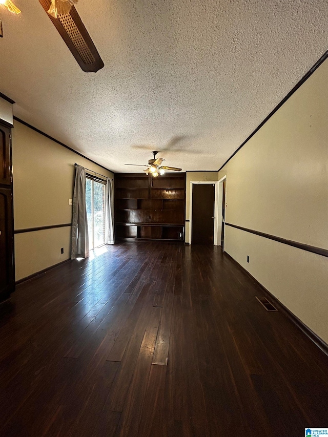 unfurnished living room featuring visible vents, a textured ceiling, a ceiling fan, and dark wood-style flooring