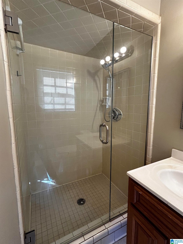 full bathroom with a shower stall and vanity