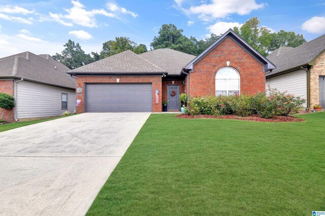 view of front of property with a garage and a front yard