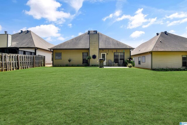 rear view of house with a yard