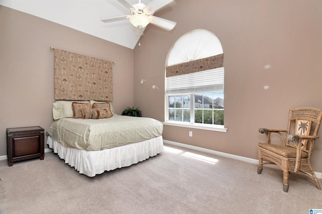 carpeted bedroom featuring ceiling fan and vaulted ceiling