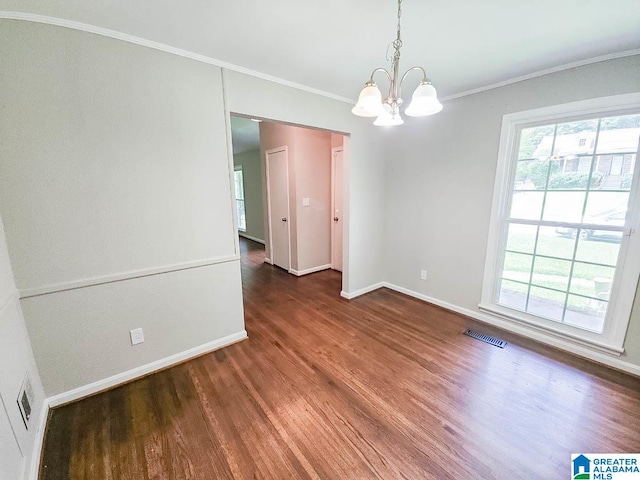 interior space featuring crown molding, a healthy amount of sunlight, an inviting chandelier, and dark hardwood / wood-style flooring