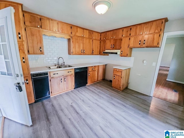 kitchen with dishwasher, sink, light hardwood / wood-style flooring, and decorative backsplash