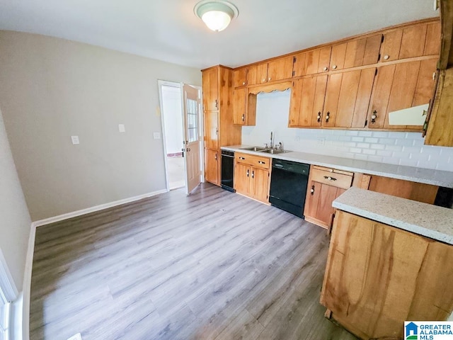 kitchen with dishwasher, sink, decorative backsplash, and light hardwood / wood-style floors