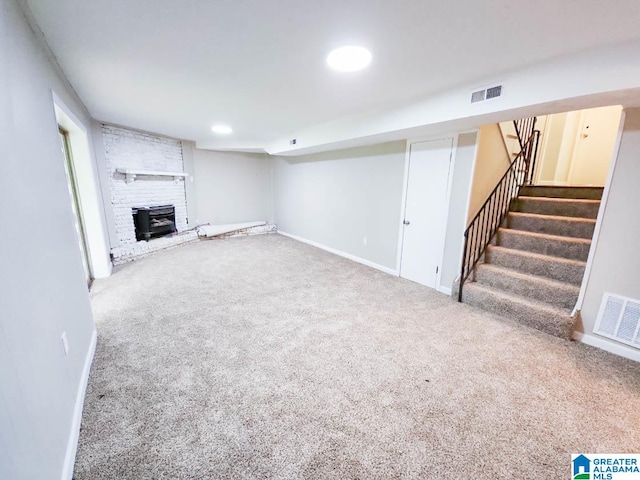 unfurnished living room featuring carpet flooring and a fireplace