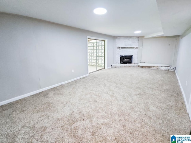 unfurnished living room featuring a fireplace and carpet floors