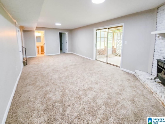 unfurnished living room with a fireplace and carpet floors