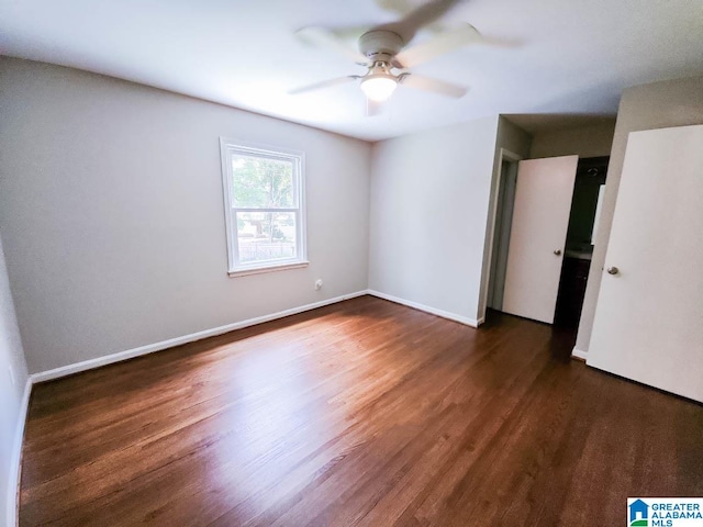 unfurnished bedroom featuring dark wood-type flooring and ceiling fan