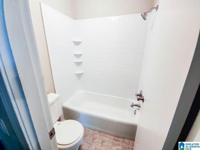 bathroom with toilet, shower / bathtub combination, and tile patterned floors