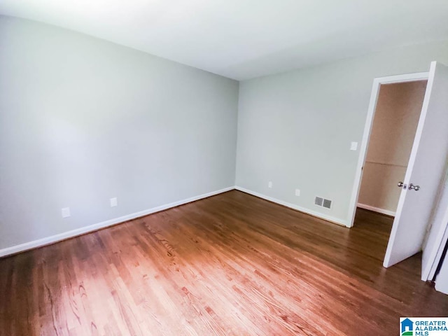 spare room with hardwood / wood-style flooring