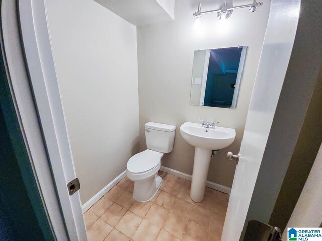 bathroom featuring toilet and tile patterned floors