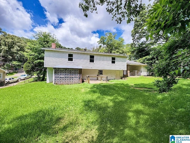 back of house featuring a yard