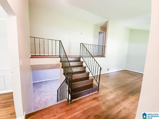 stairway with hardwood / wood-style flooring