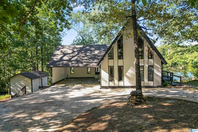 view of front of property with a storage unit and a carport