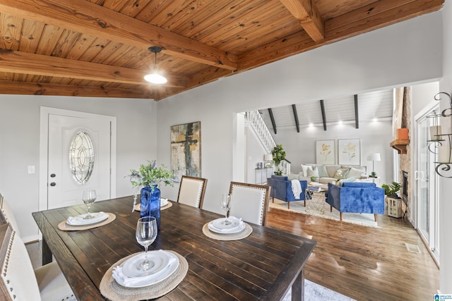 dining room featuring visible vents, wood finished floors, wooden ceiling, and beam ceiling