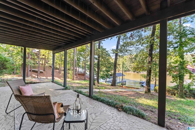 sunroom featuring plenty of natural light and a water view