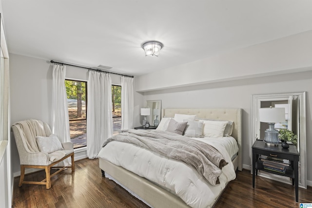 bedroom featuring visible vents, access to outside, and dark wood finished floors