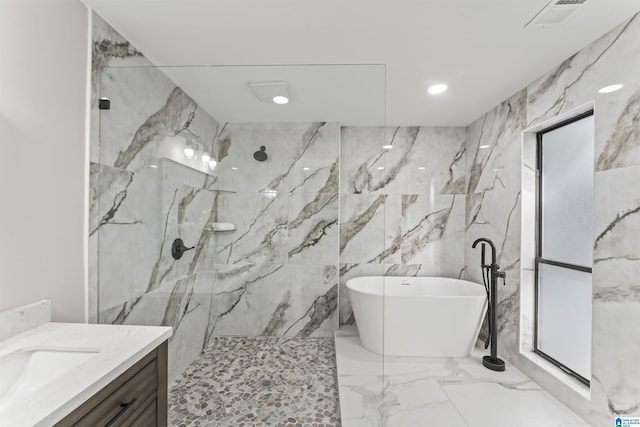 full bathroom featuring visible vents, marble finish floor, a marble finish shower, vanity, and a freestanding bath