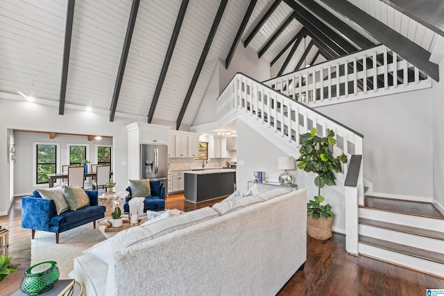 living room featuring high vaulted ceiling, dark hardwood / wood-style floors, and beamed ceiling