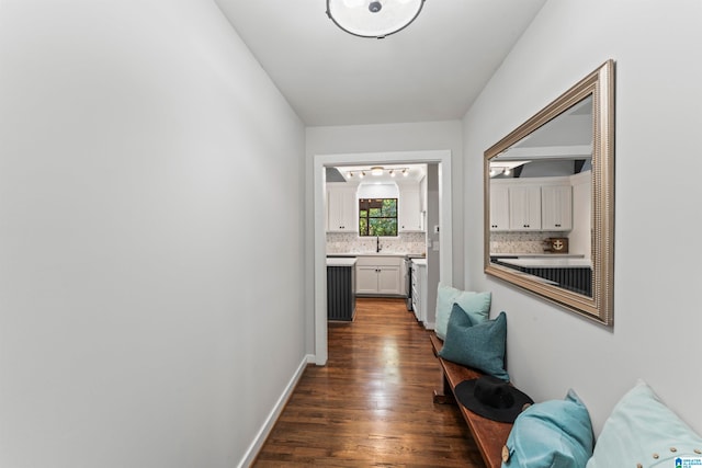 corridor featuring dark hardwood / wood-style flooring and sink