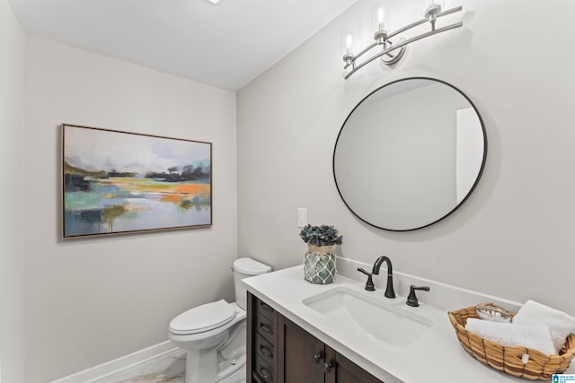 bathroom featuring toilet and vanity