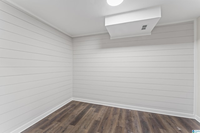 interior space with baseboards, visible vents, and dark wood-style flooring