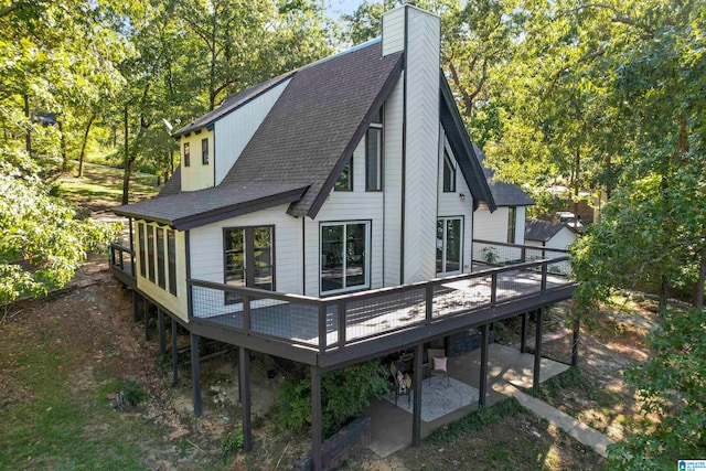 back of property with a wooden deck