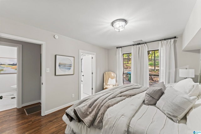 bedroom featuring dark hardwood / wood-style flooring and connected bathroom