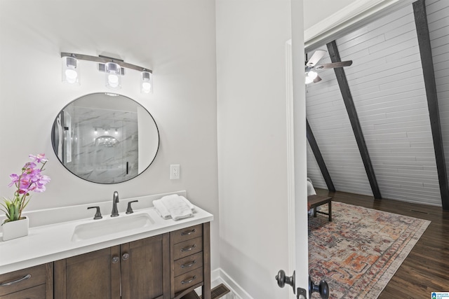 bathroom with visible vents, baseboards, ceiling fan, wood finished floors, and vanity