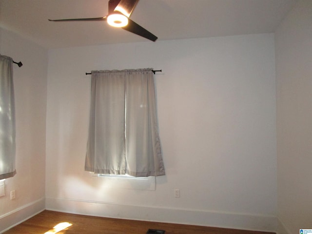 empty room with hardwood / wood-style floors and ceiling fan
