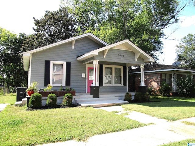 view of front facade with a front lawn and a porch