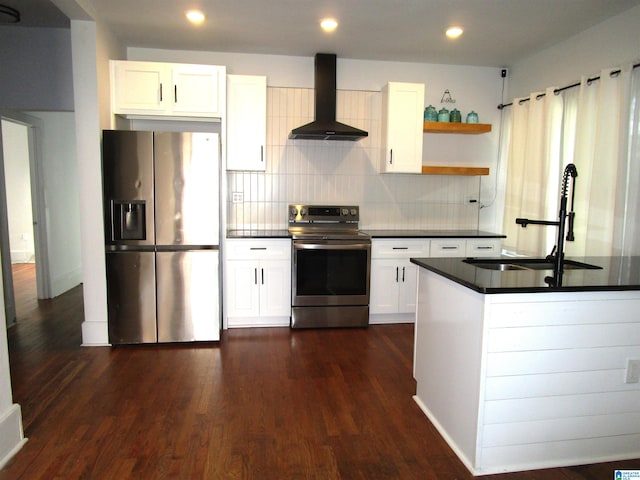 kitchen featuring wall chimney range hood, white cabinets, dark wood-type flooring, and stainless steel appliances