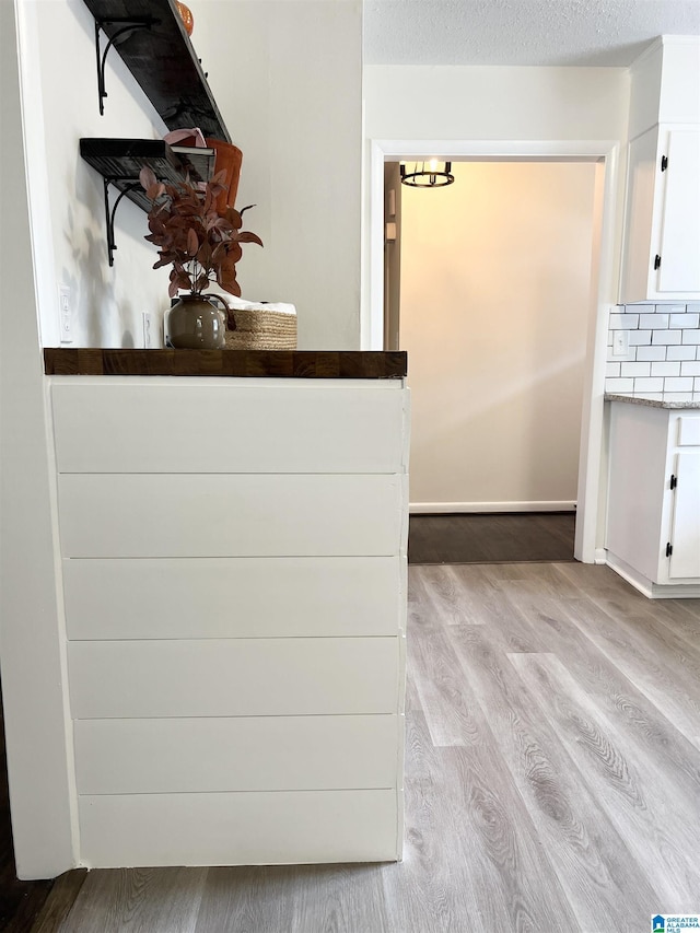 room details featuring a textured ceiling and wood finished floors