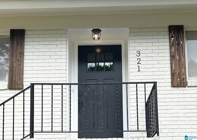 view of exterior entry with covered porch