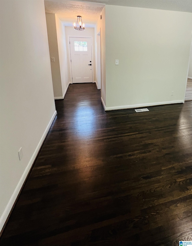 interior space featuring baseboards and dark wood-type flooring