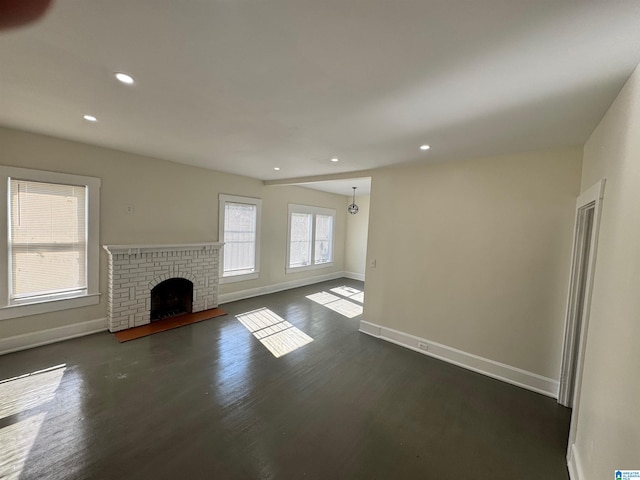 unfurnished living room with dark wood-type flooring and a fireplace