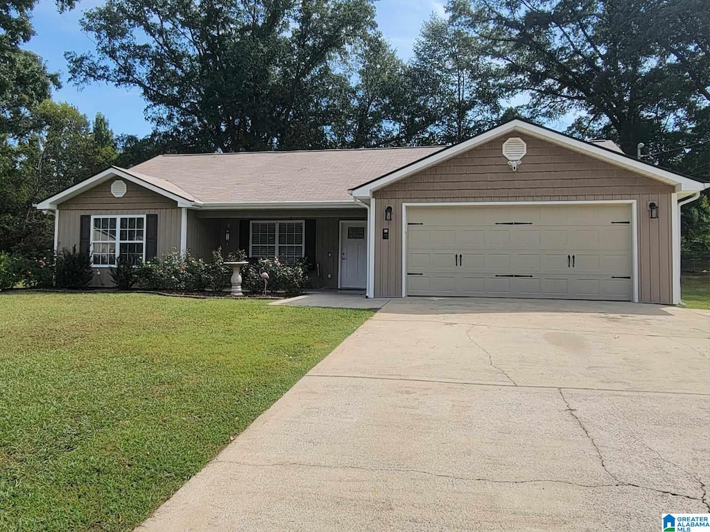 ranch-style house featuring a garage and a front yard