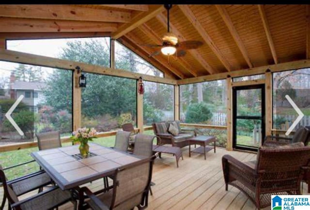 sunroom / solarium with vaulted ceiling with beams, ceiling fan, and a healthy amount of sunlight