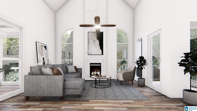 living room featuring hardwood / wood-style floors, ceiling fan, a fireplace, and high vaulted ceiling