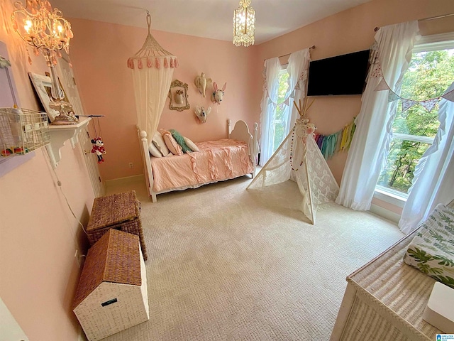 carpeted bedroom featuring a chandelier