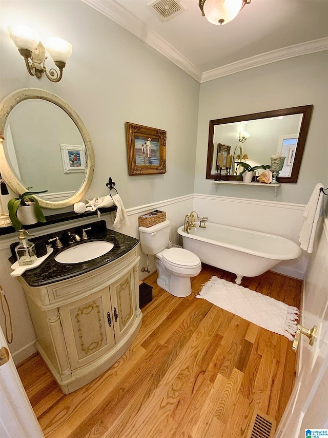 bathroom featuring vanity, toilet, a bathtub, and hardwood / wood-style flooring