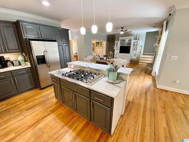 kitchen with ornamental molding, light hardwood / wood-style flooring, decorative light fixtures, stainless steel appliances, and ceiling fan