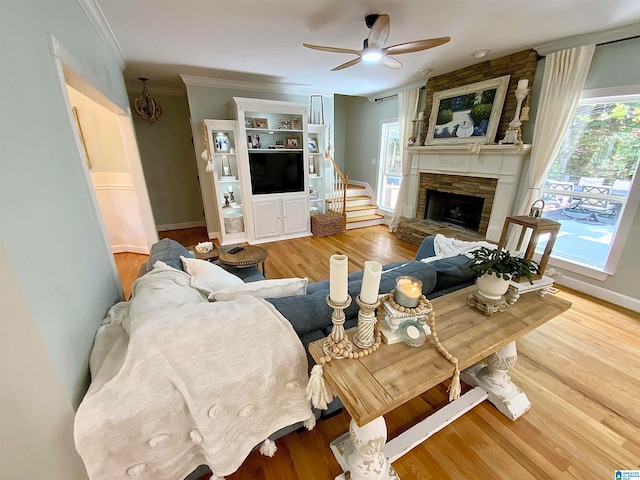 living room featuring a fireplace, a healthy amount of sunlight, and ceiling fan