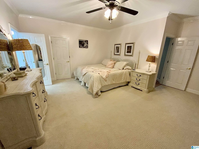 carpeted bedroom featuring crown molding and ceiling fan