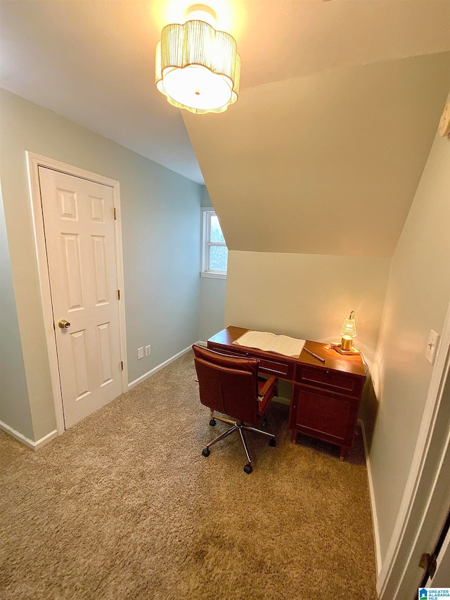 carpeted office featuring lofted ceiling