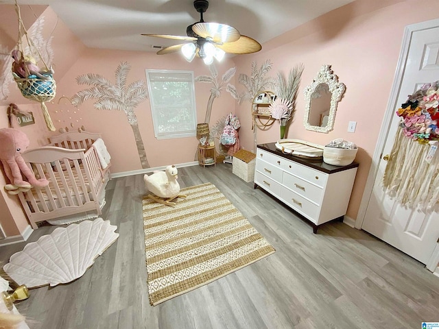 sitting room with light hardwood / wood-style flooring and ceiling fan