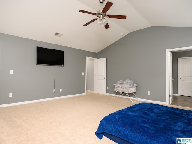 carpeted bedroom with ceiling fan and vaulted ceiling